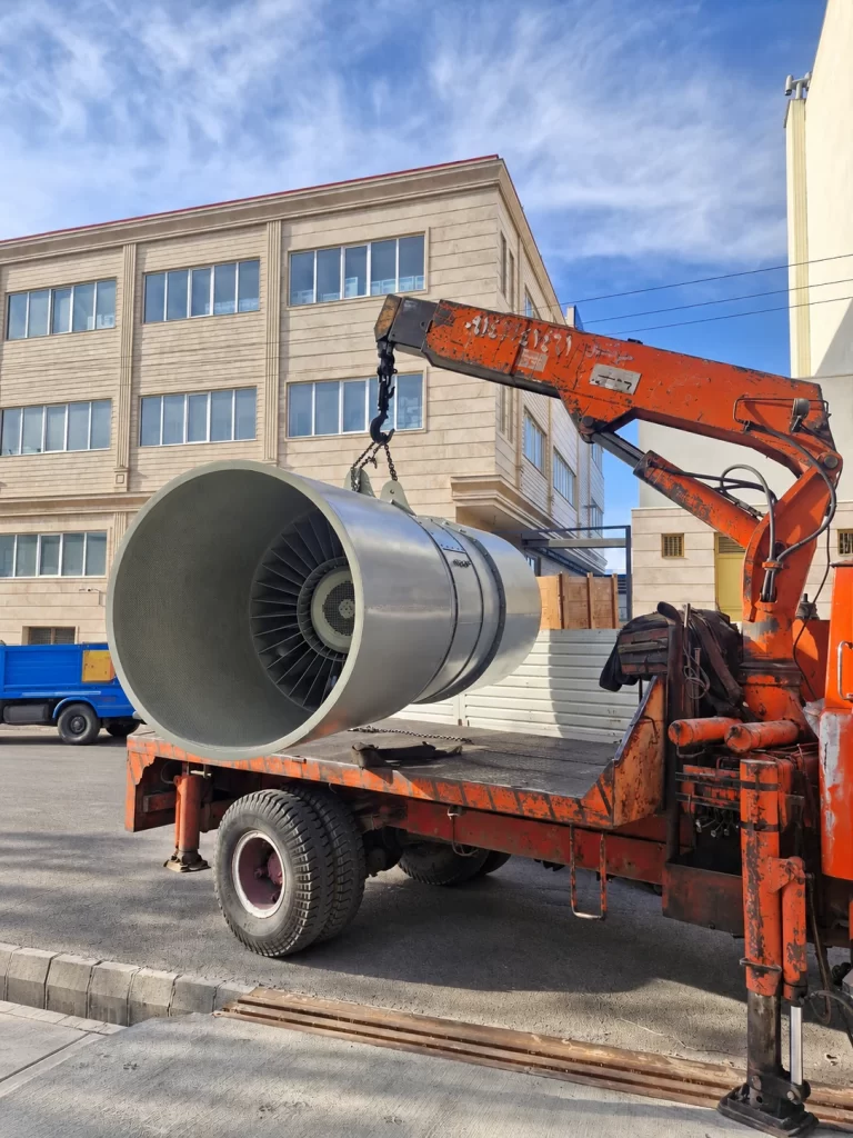 Industrial axial fan being loaded by crane outside the factory